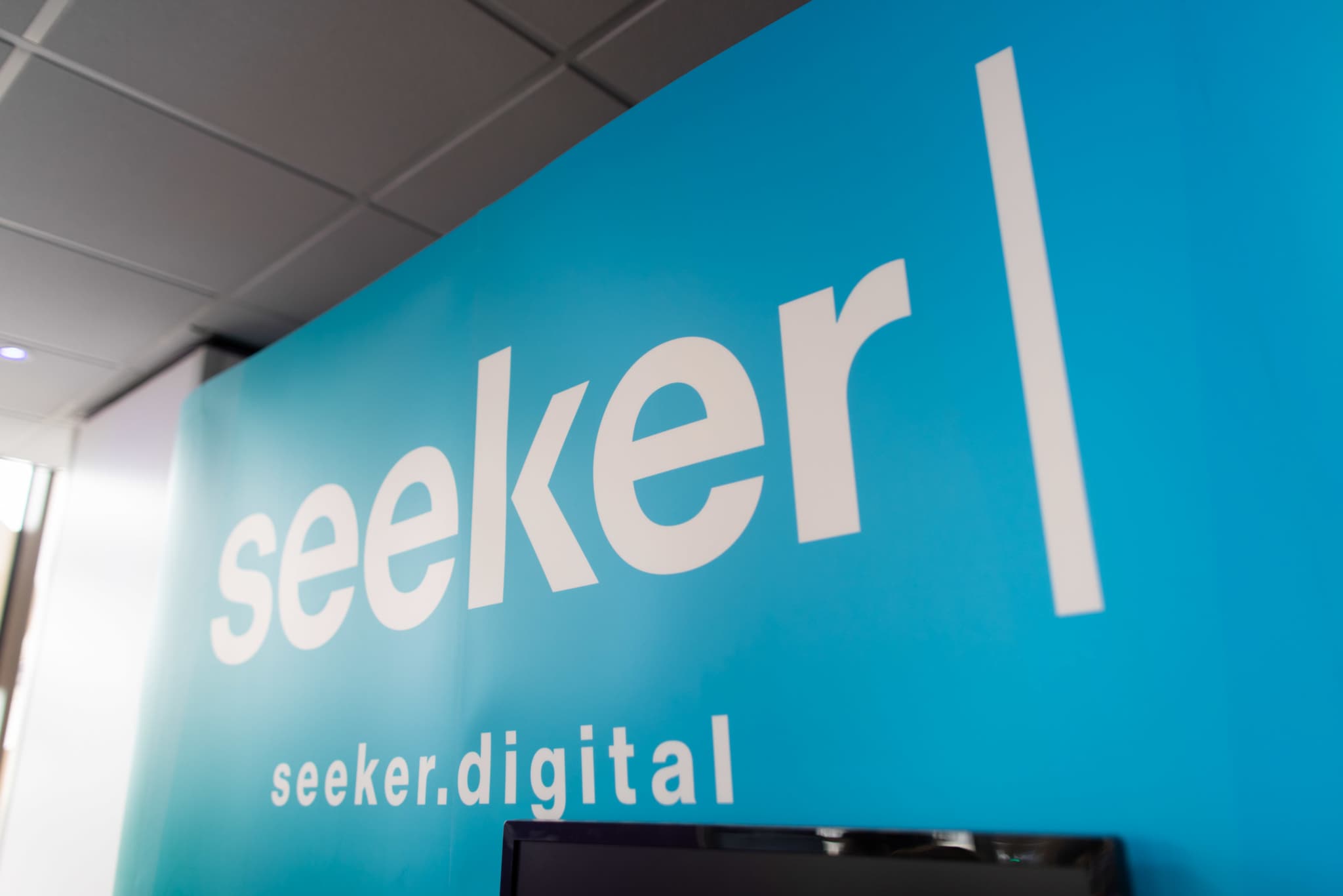 The Seeker Digital wall logo in blue
